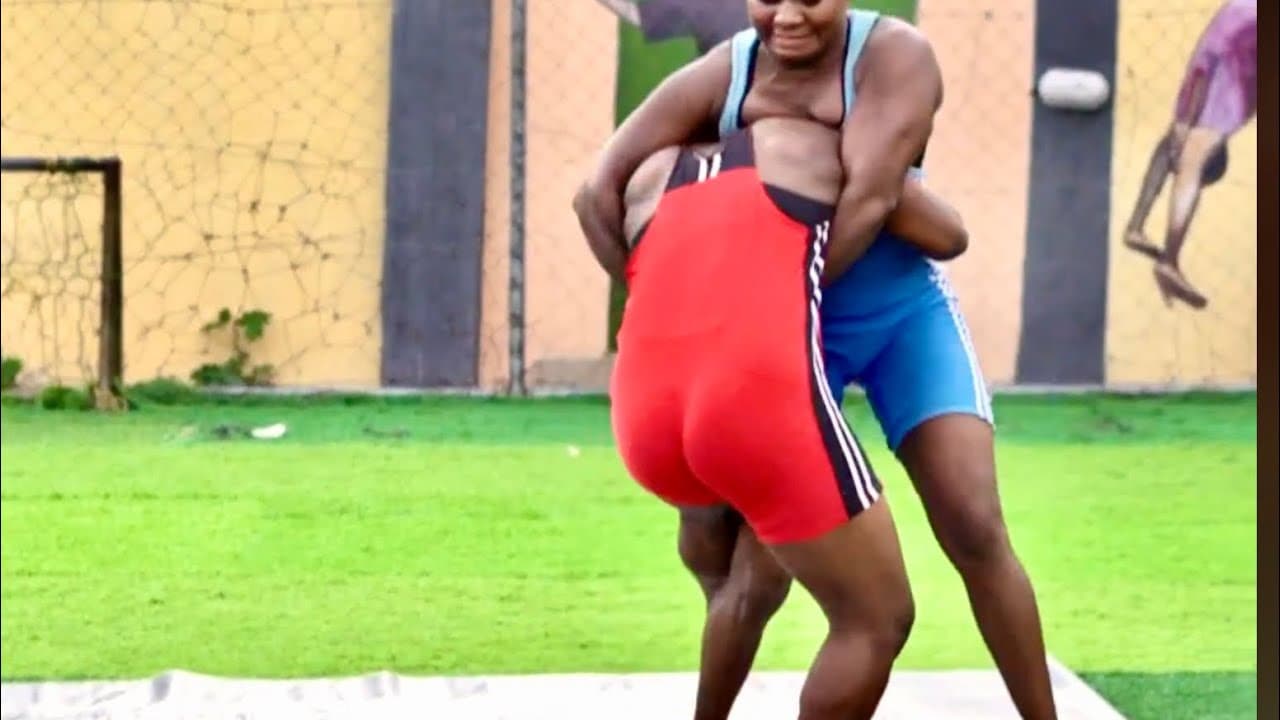 Two tough girls wrestling in the open court